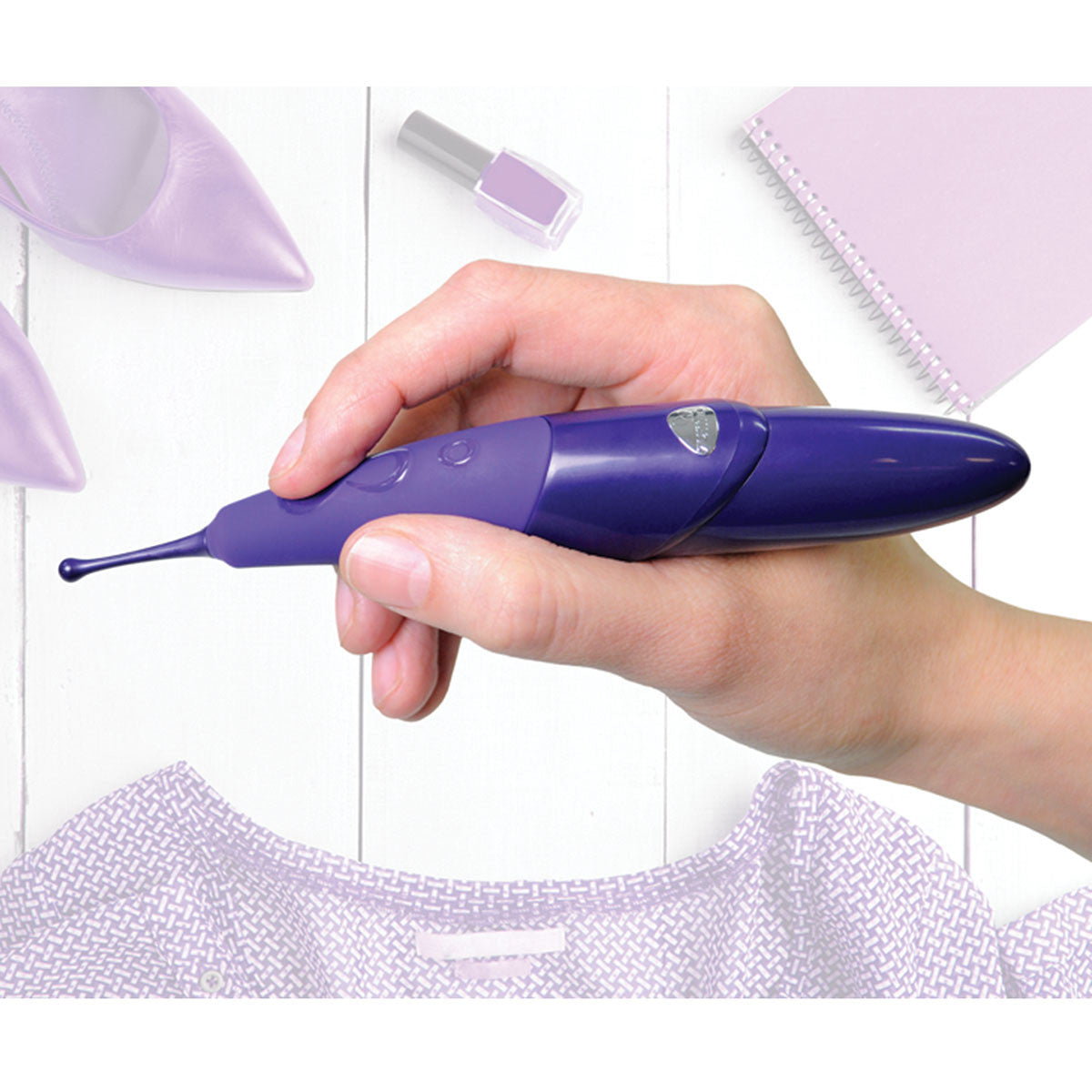 Hand holding Zumio Clitoral Stimulator