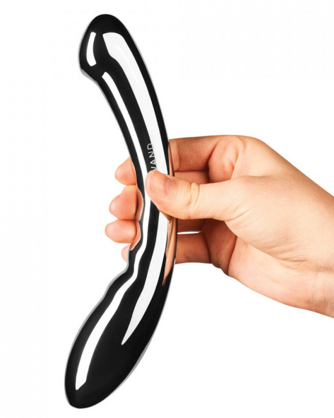 Le Wand Arch Double Ended Stainless Steel Dildo held at the center by a person's hand to illustrate the size of the dildo
