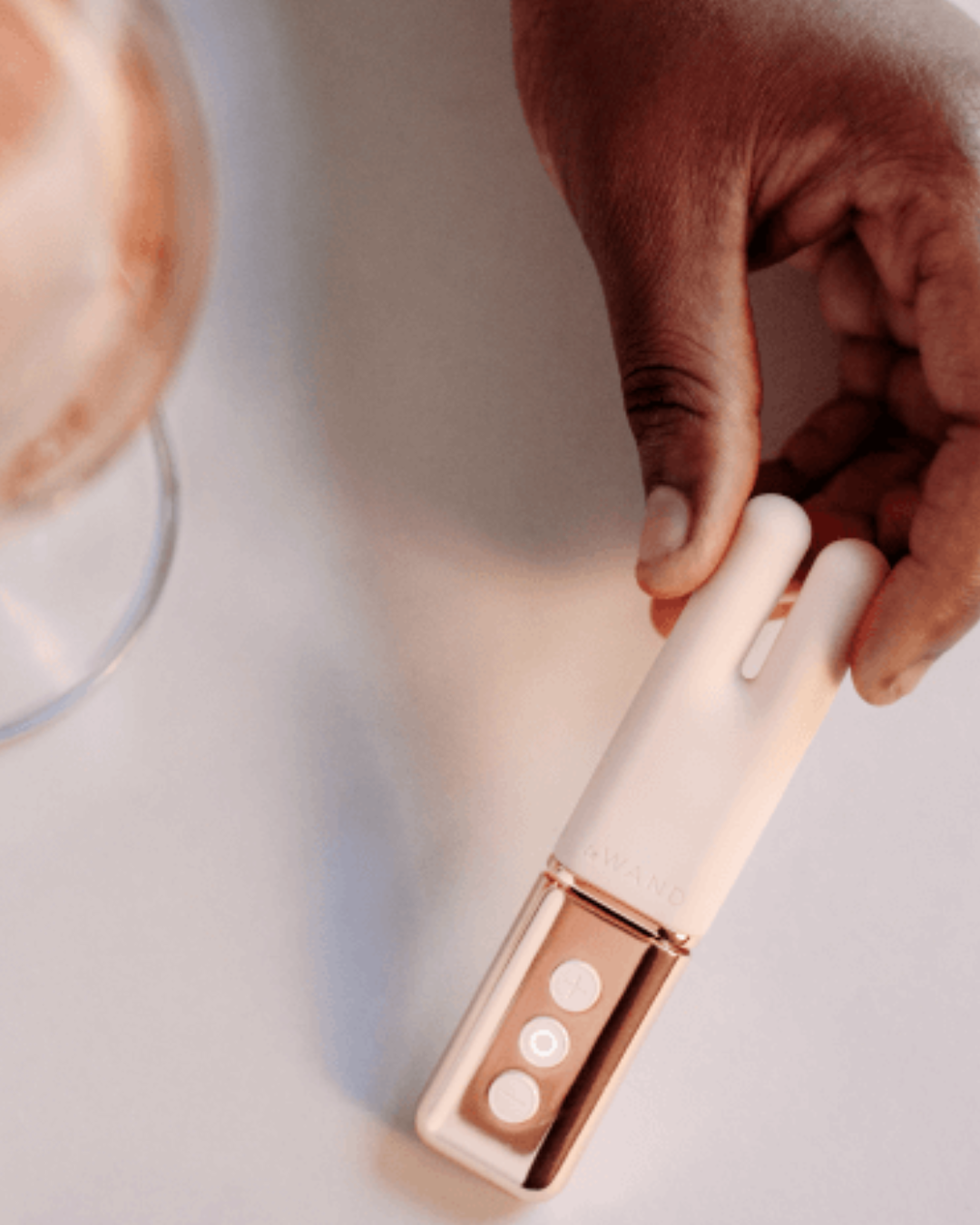 Le Wand Deux Twin Motor Rechargeable Waterproof Vibrator - Rose Gold held in a hand