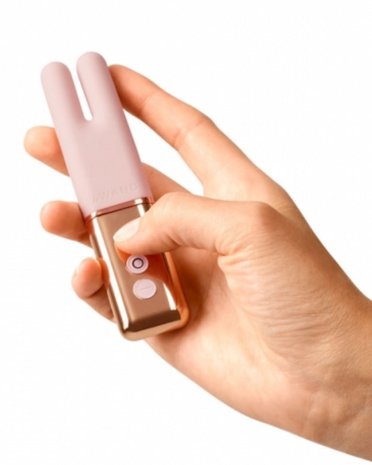 Le Wand Deux Twin Motor Rechargeable Waterproof Vibrator - Rose Gold held in a hand
