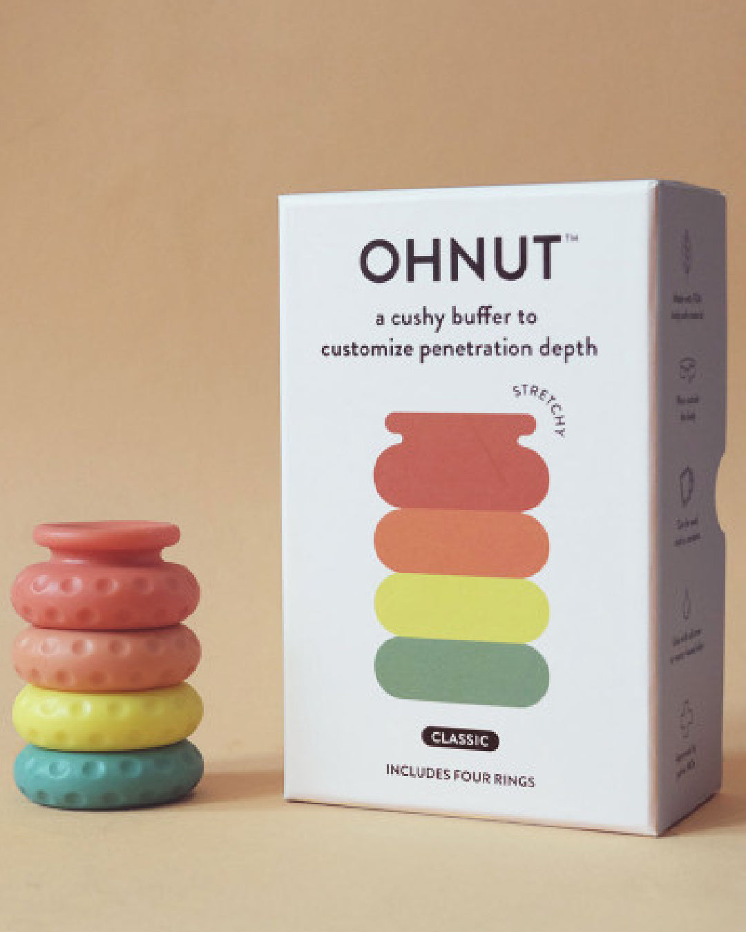 Ohnut Set of 4 Wearable Penetration Adjustment Rings - Rainbow rings next to white product box with a beige background