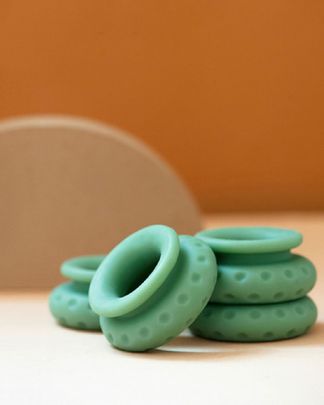 Ohnut Wide Set of 4 Wearable Penetration Adjustment Rings side by side with orange background