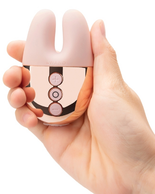 Le Wand Chrome Double Vibrator - Rose Gold held in model's hand