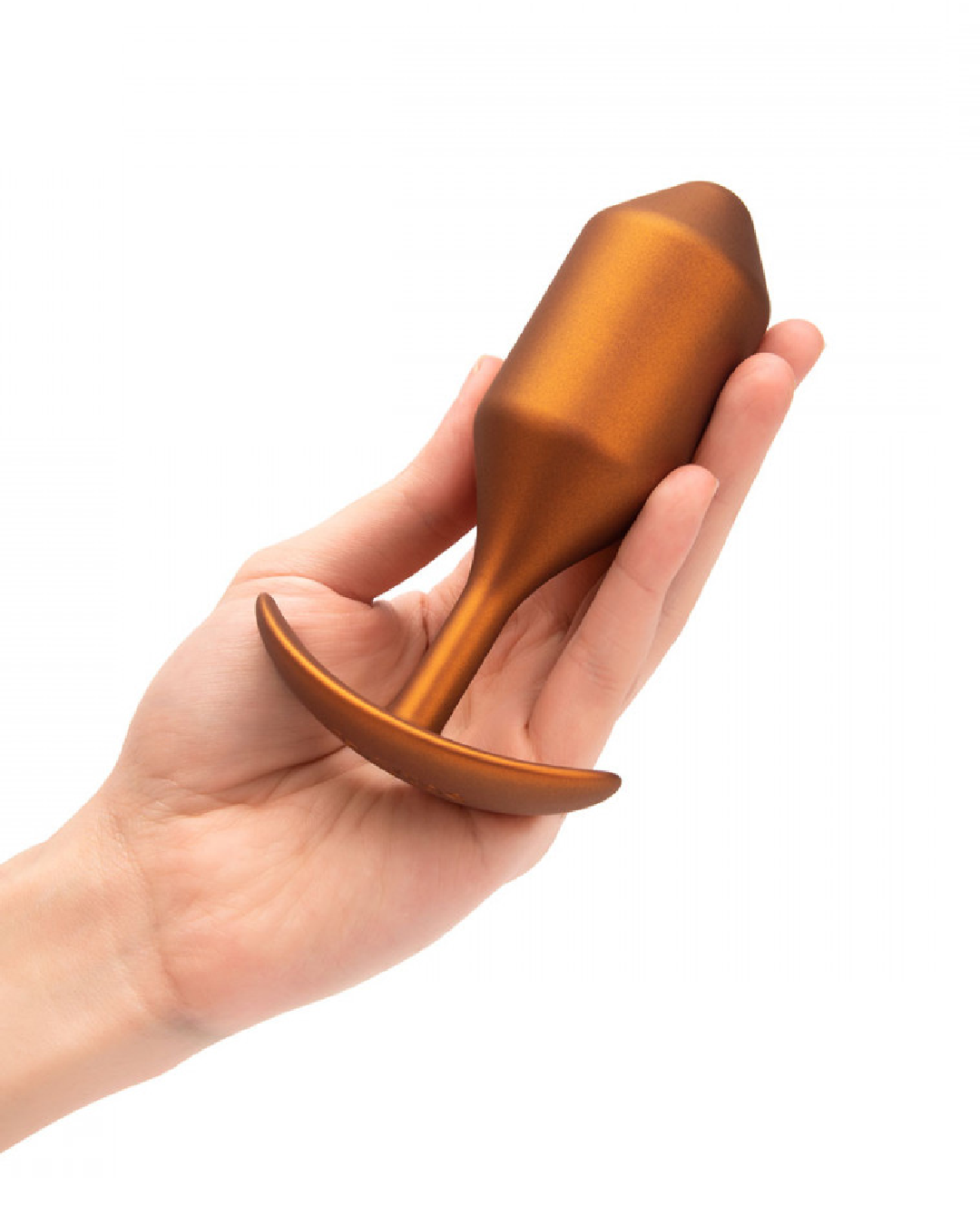 B-vibe Snug Plug 4 XL Weighted Silicone Butt Plug (257 grams) - Sunburst Orange held in a hand