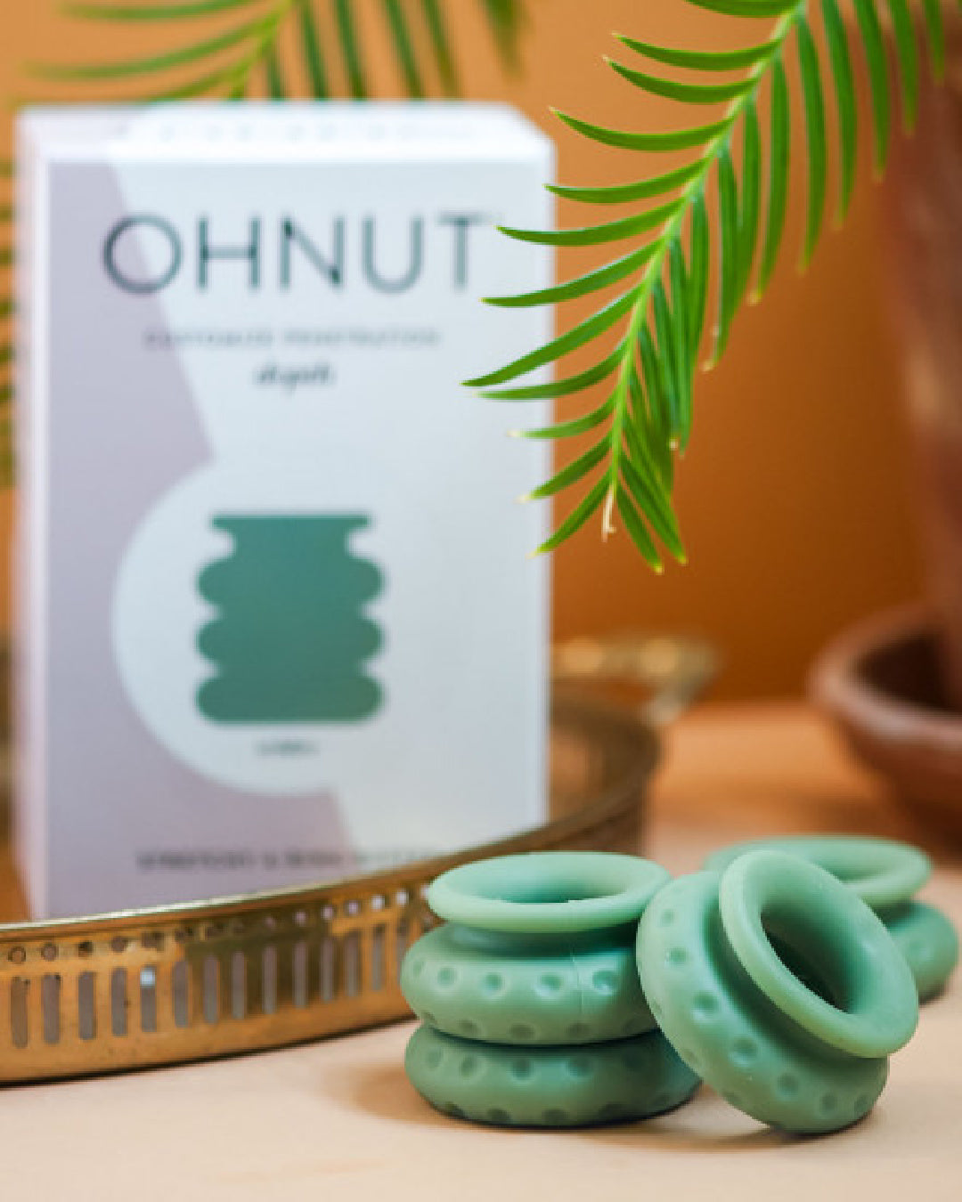 Ohnut Wide Set of 4 Wearable Penetration Adjustment Rings and box with plant in background