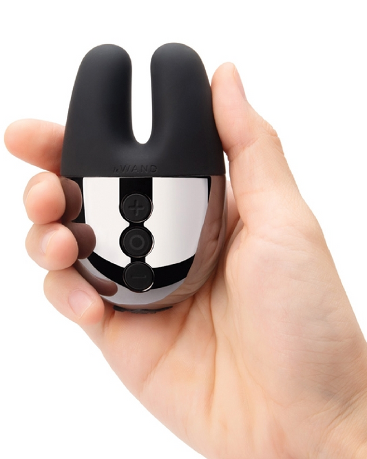 Le Wand Chrome Double Vibrator -Black being held in a model's hand