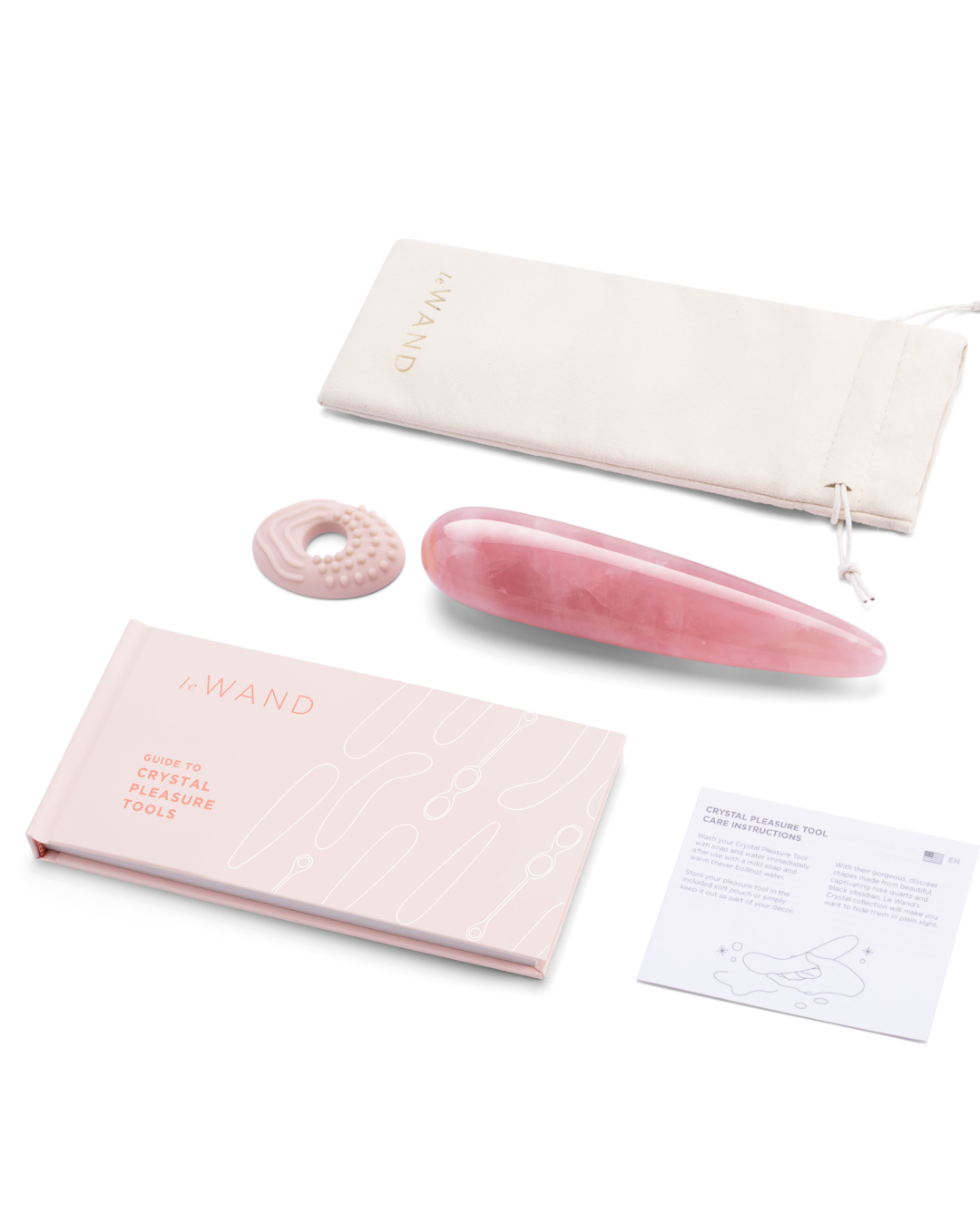 Le Wand Crystal  Wand - Rose Quartz next to silicone textured ring and storage pouch and user manual