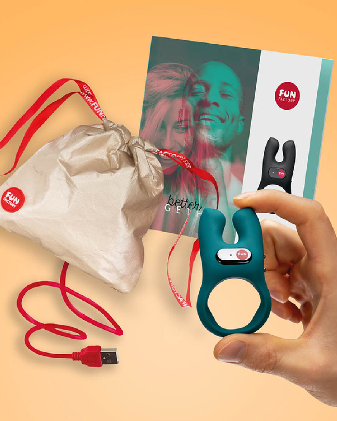 Fun Factory NŌS Vibrating Couples Penis Ring - Blue HELD IN A HAND IN FRONT OF BOX CONTENTS - BAG, CORD, INSTRUCTIONS
