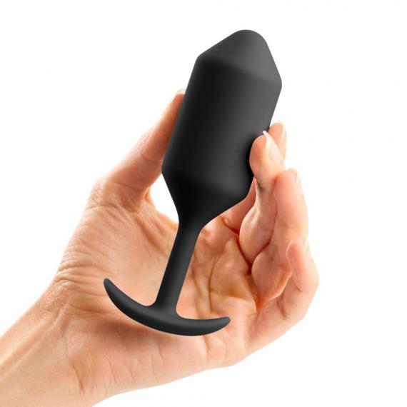 B-vibe Snug Plug 3 Weighted Silicone Butt Plug - 180 grams - Various Colors held in a hand