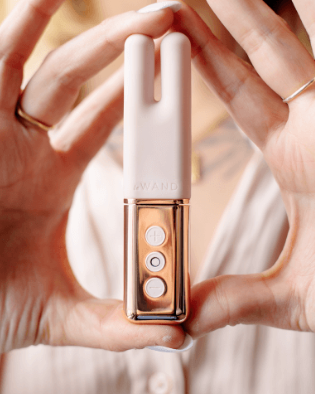 Le Wand Deux Twin Motor Rechargeable Waterproof Vibrator - Rose Gold held in two hands