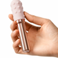 Le Wand Chrome Grand Bullet Waterproof Rechargeable Metal Bullet with Texture Sleeve - Rose Gold held in a hand
