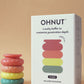 Ohnut Wide Set of 4 Wearable Penetration Adjustment Rings -Rainbow colored rings next to white product box on beige background 