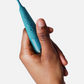 Zumio i - Rechargeable Clitoral Stimulator -Teal in model's hand 
