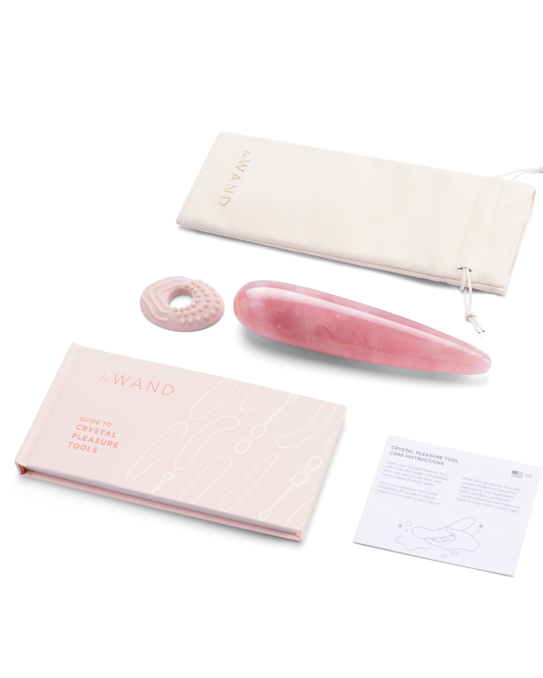 Le Wand Crystal  Wand - Rose Quartz next to silicone textured ring and storage pouch and user manual 