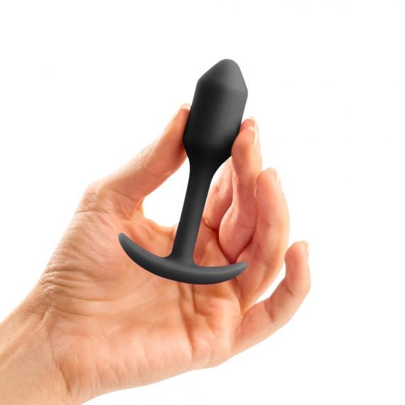 Hand holding B-vibe Snug Plug 1 Weighted Silicone Butt Plug - 55 grams black